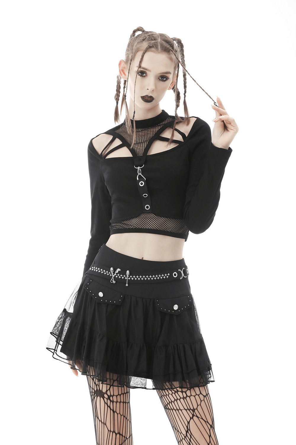 Gothic woman in a black short pleated skirt with chains and studs, showcasing punk style and edgy fashion.