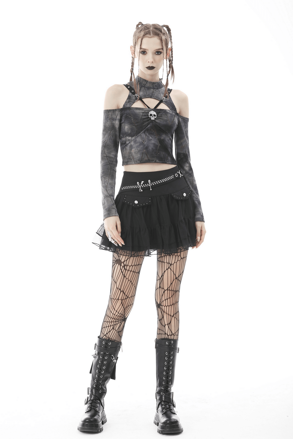 Gothic woman in black mini pleated skirt with chains, edgy top, fishnet stockings, and combat boots, capturing punk rock allure.