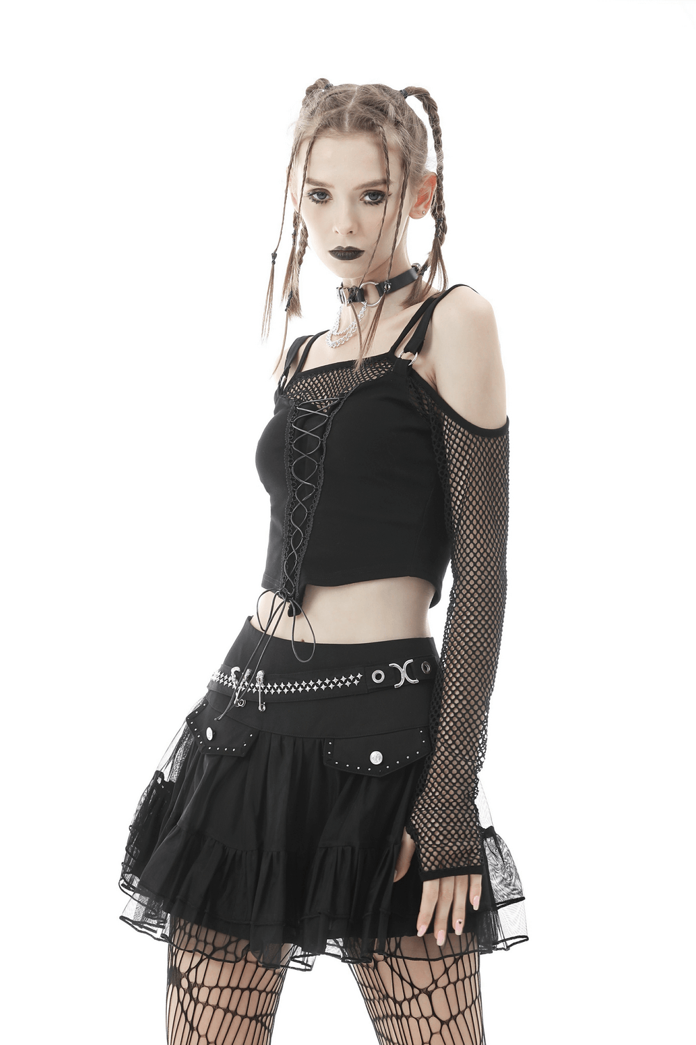 Gothic women's short pleated skirt with chains and studs, paired with a stylish black mesh top and fishnet sleeves.