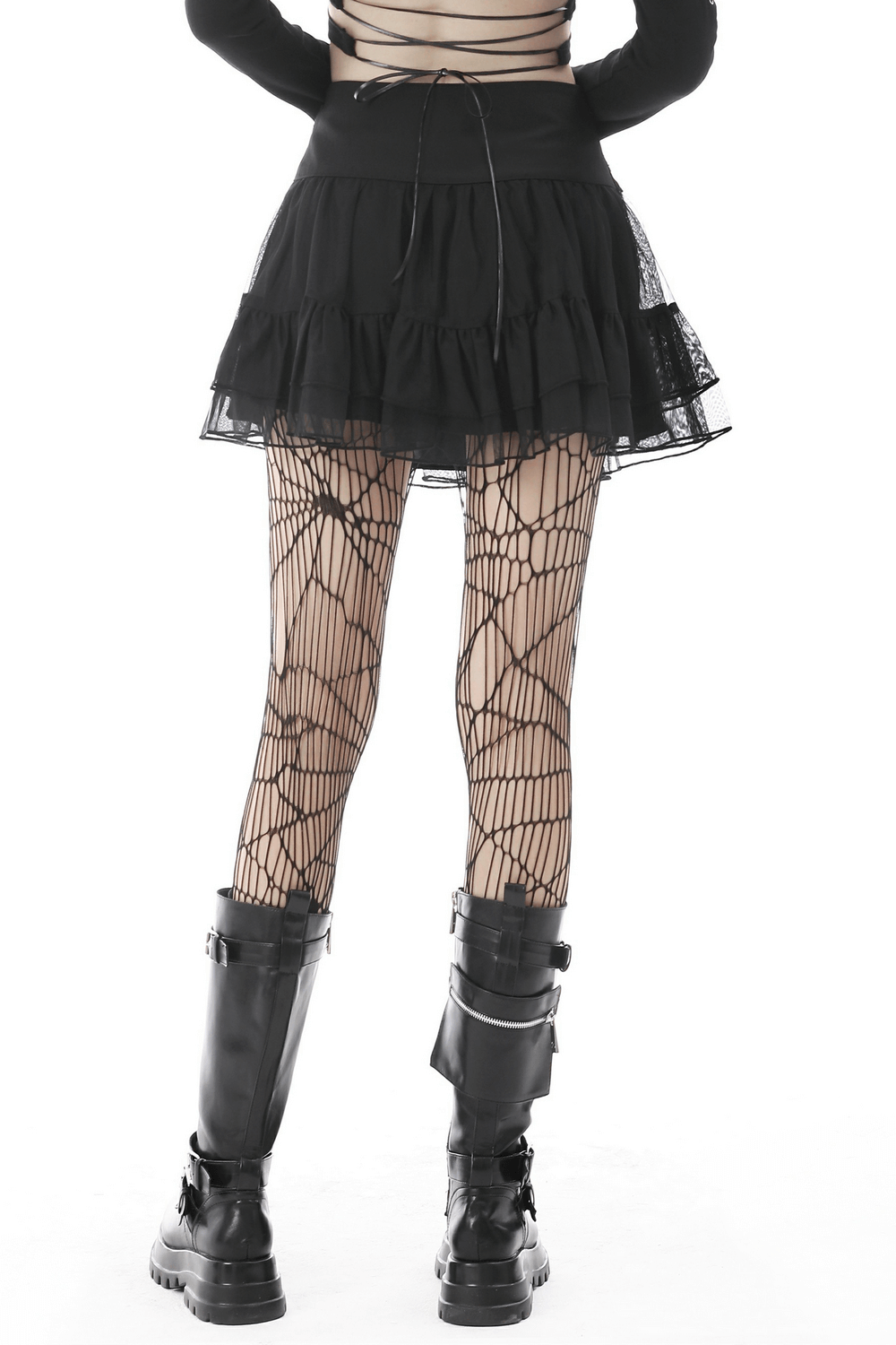 Back view of a model in a Gothic mini skirt with ruffles, pairing with spider web tights and chunky boots.