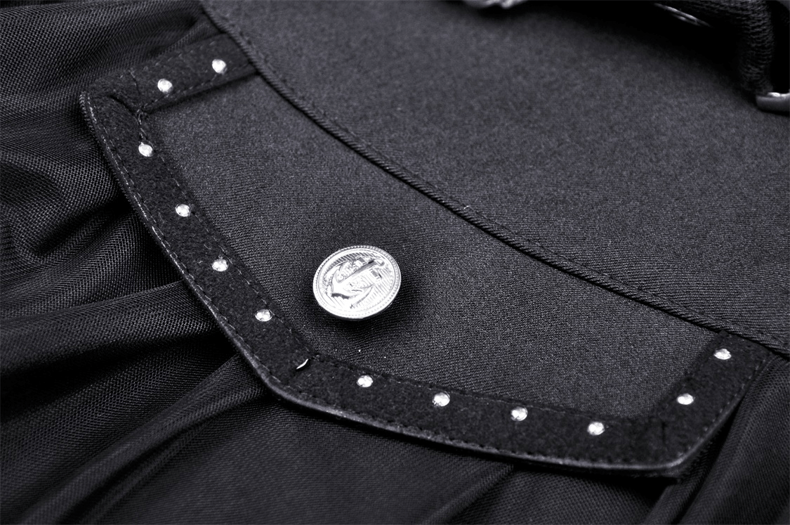 Close-up of the black gothic mini skirt's embroidered flap with studs and decorative button.