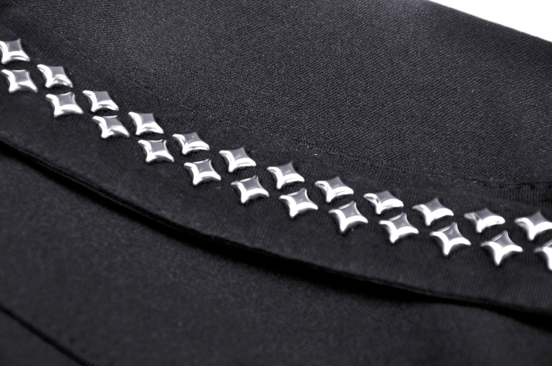 Close-up of silver studs on a black Gothic mini skirt, showcasing edgy punk rock details and stylish design.