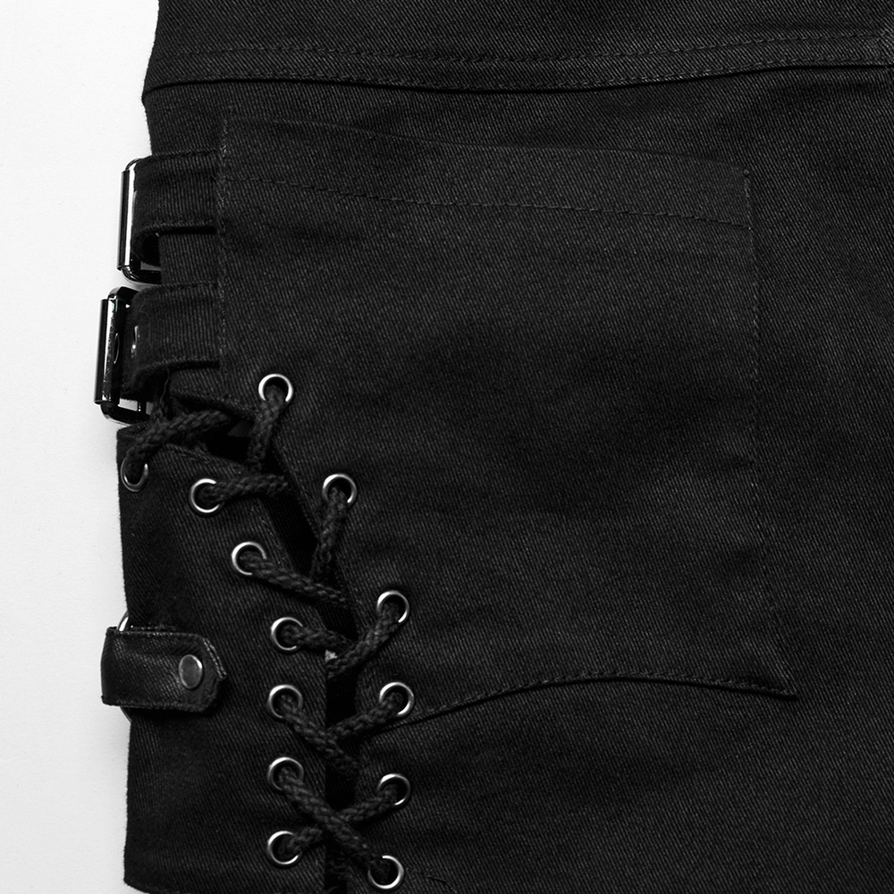 Close-up of gothic women's black shorts with side laces and buckle detail for an edgy punk style.