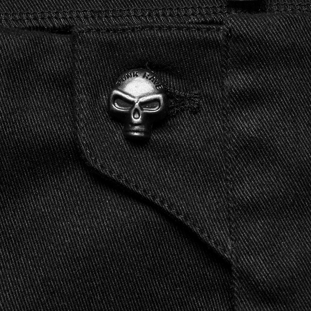 Close-up of gothic women's shorts with skull button detail, showcasing edgy punk style and black fabric.