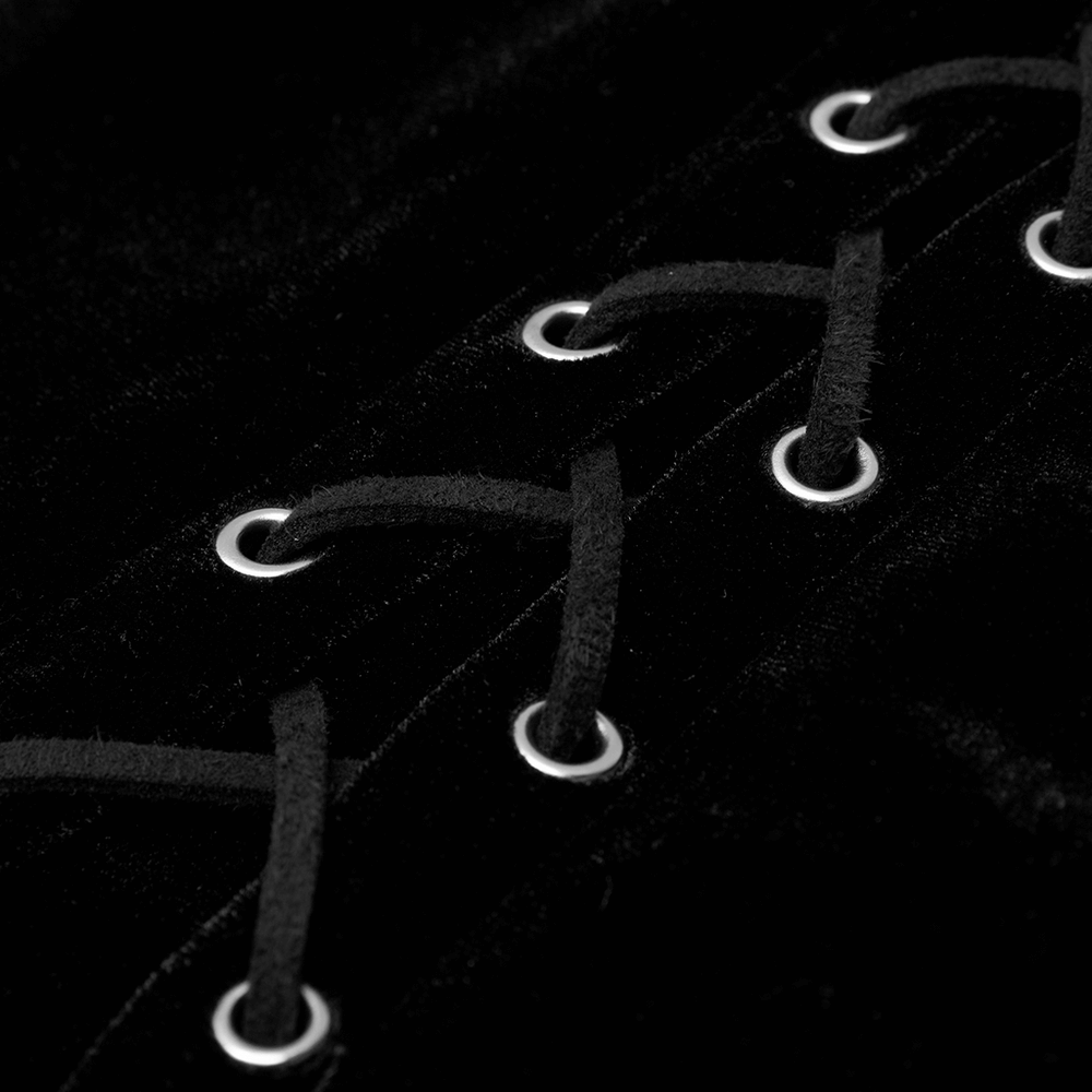 Close-up of gothic velvet dress showing black lacing and silver eyelets for a punk-inspired look.