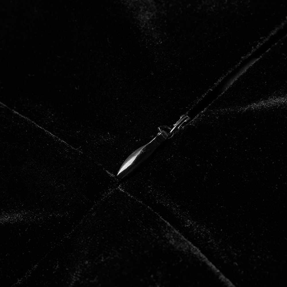 Close-up of the zipper detail on a black velvet suspender dress, showcasing its luxurious fabric and edgy style.