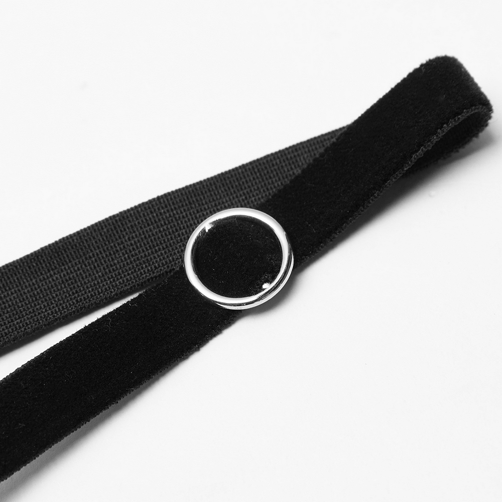 Close-up of a black velvet suspender strap with metal ring detail for Gothic women's dress.