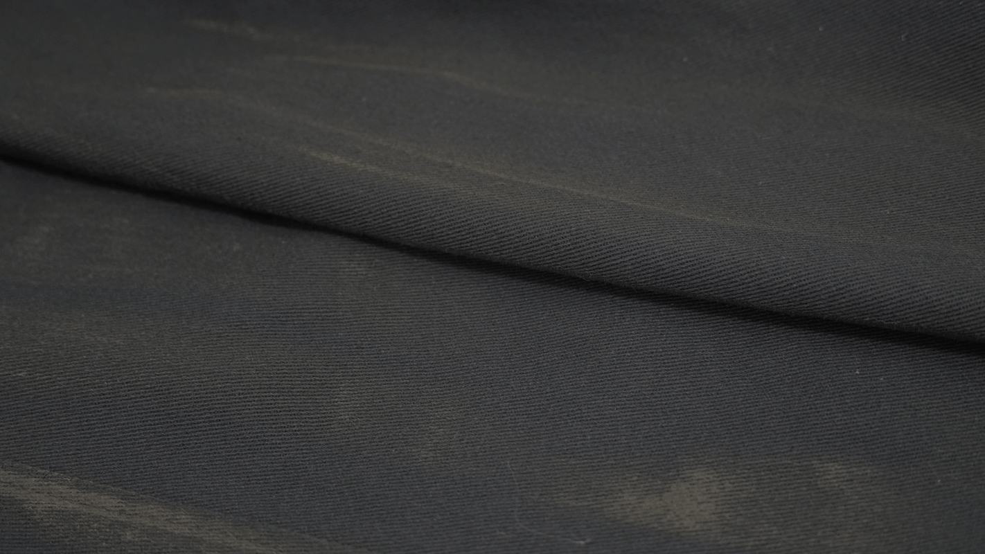 Close-up of gothic trench coat fabric in black, showcasing quality material texture for a stylish look.