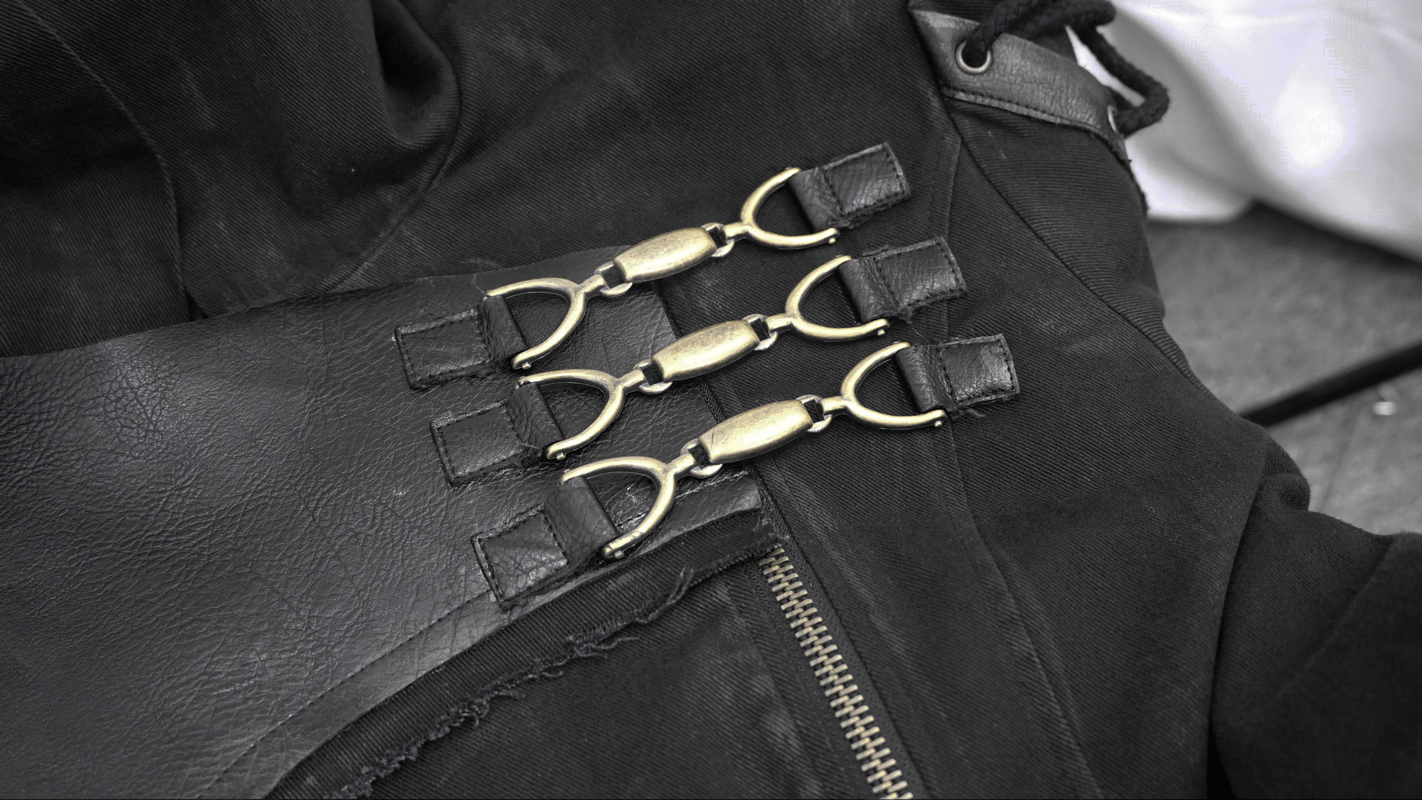 Close-up of gothic trench coat buckle details highlighting quality craftsmanship and retro style.