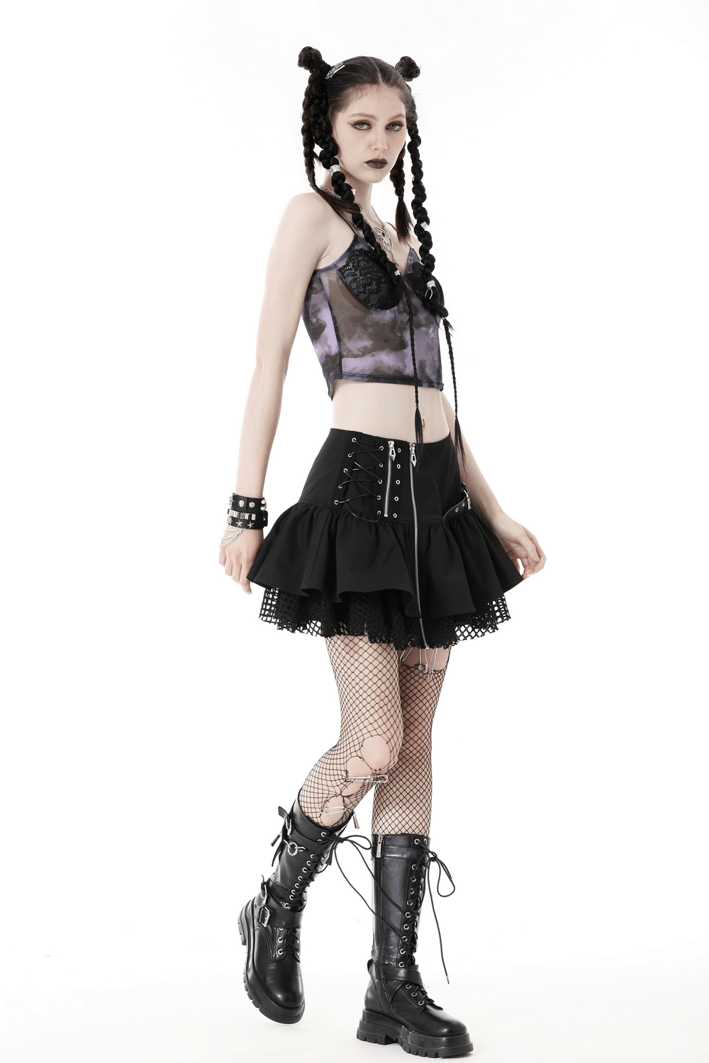 Gothic model wearing a lace-up mini skirt with buckle details, fishnet stockings, and combat boots.