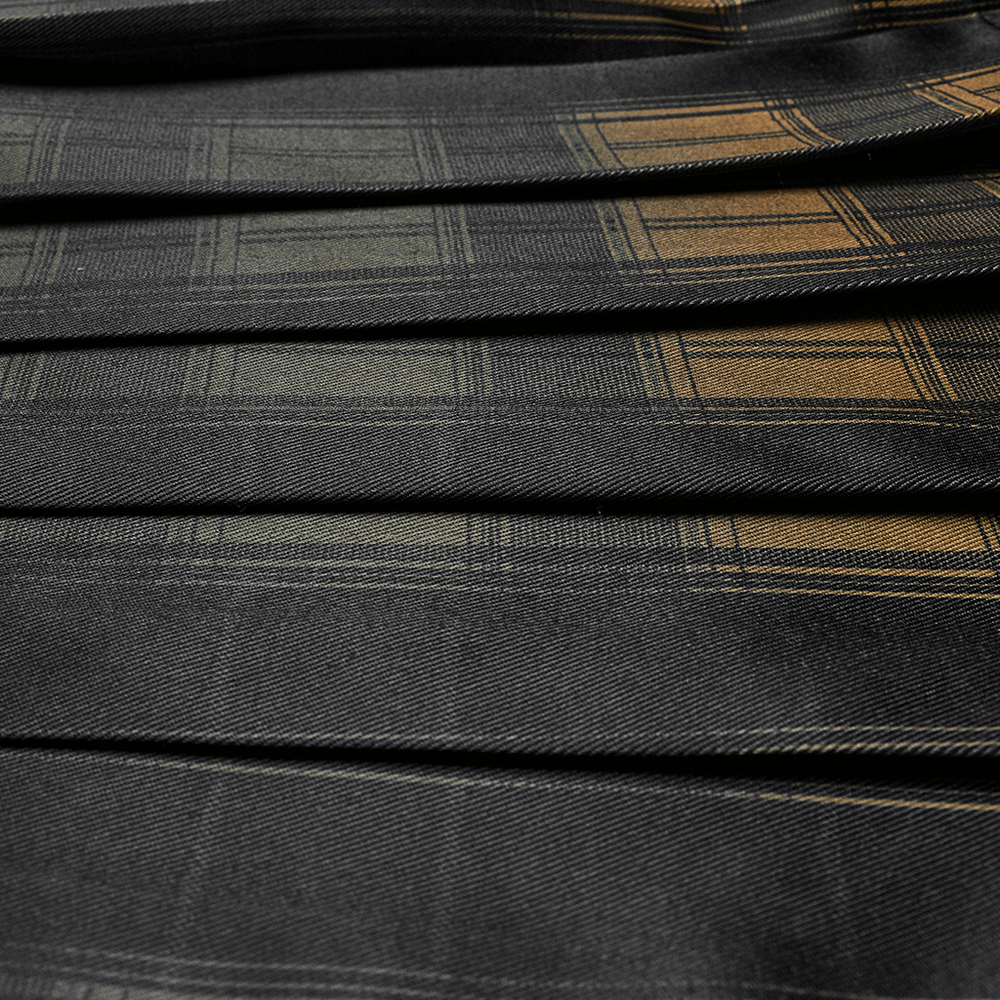 Close-up of plaid fabric featuring gradient tones in a punk Scottish kilt, showcasing vibrant visual contrast.
