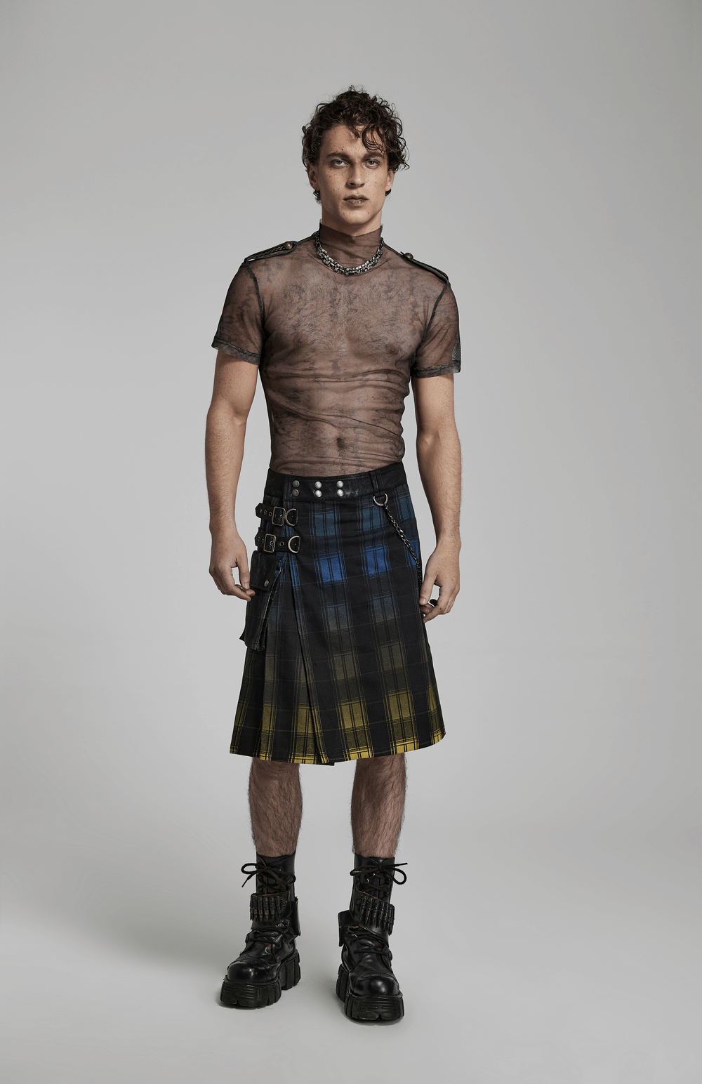 Stylish model wearing a gradient Scottish punk kilt with metal details and a sheer top, exuding bold punk fashion.