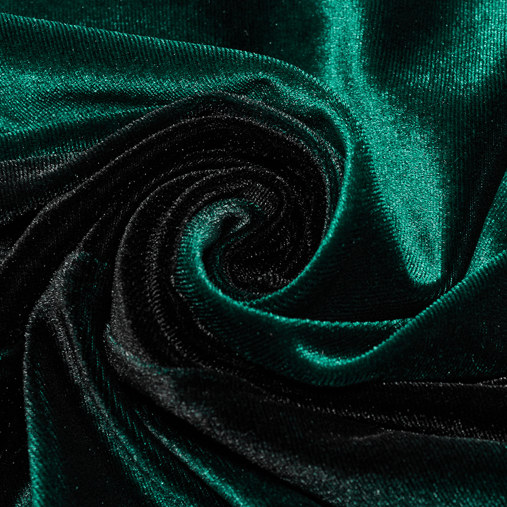 Close-up of luxurious gradient velvet fabric in deep green and black, showcasing texture and shine.
