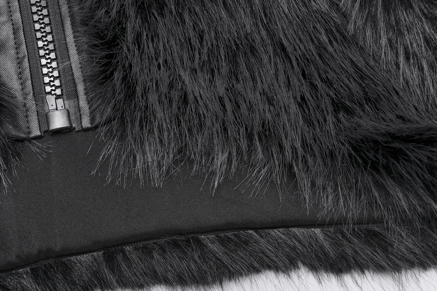 Close-up of gray faux wool fabric and zipper detail on trendy crop jacket for women.