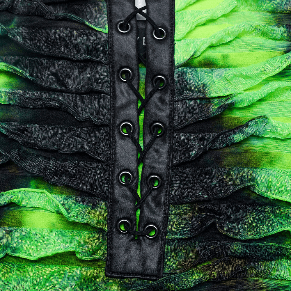 Close-up of green and black ruffle dress with adjustable straps and drawstring design for a stylish fit.