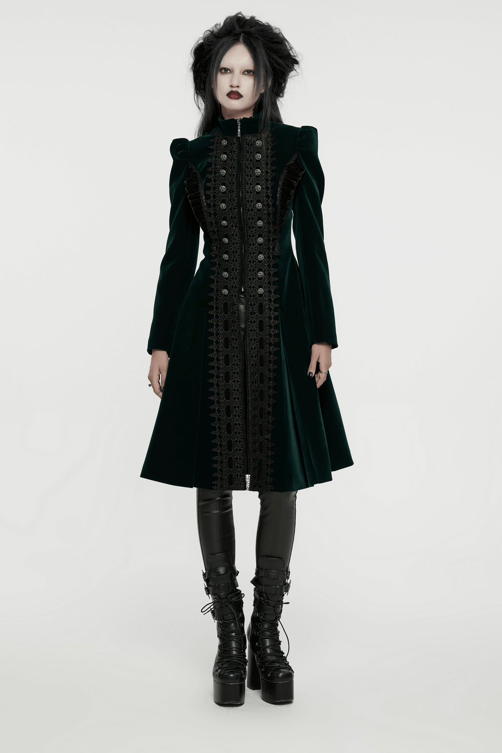 Green velvet Gothic coat with lace and ruffle details, featuring a dramatic silhouette and elegant button accents.