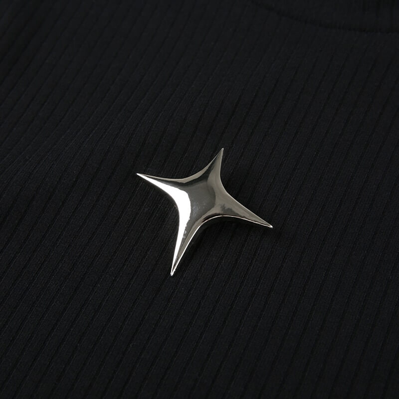 Stylish silver star brooch on a textured black fabric, adding a punk flair to any outfit.