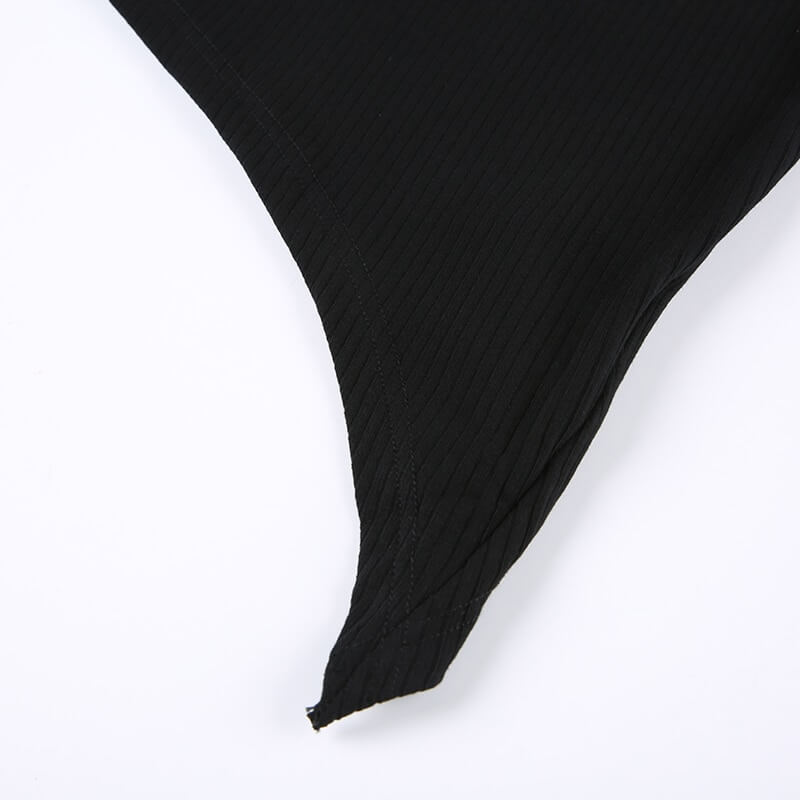 Close-up of the irregular hemline of a grunge black women's tank top showcasing punk style.