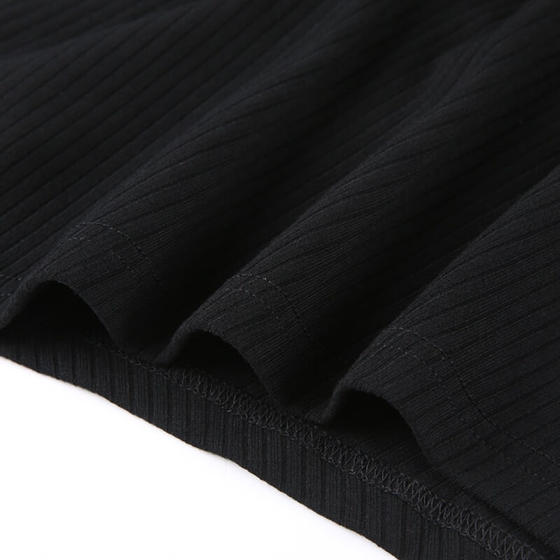 Close-up of the textured black fabric of a women's grunge sleeveless tank top showcasing a stylish ribbed design.