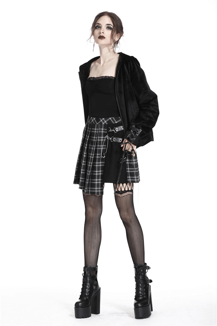 Grunge Gothic model wearing an asymmetrical plaid mini skirt with punk rock style and bold black platform boots.