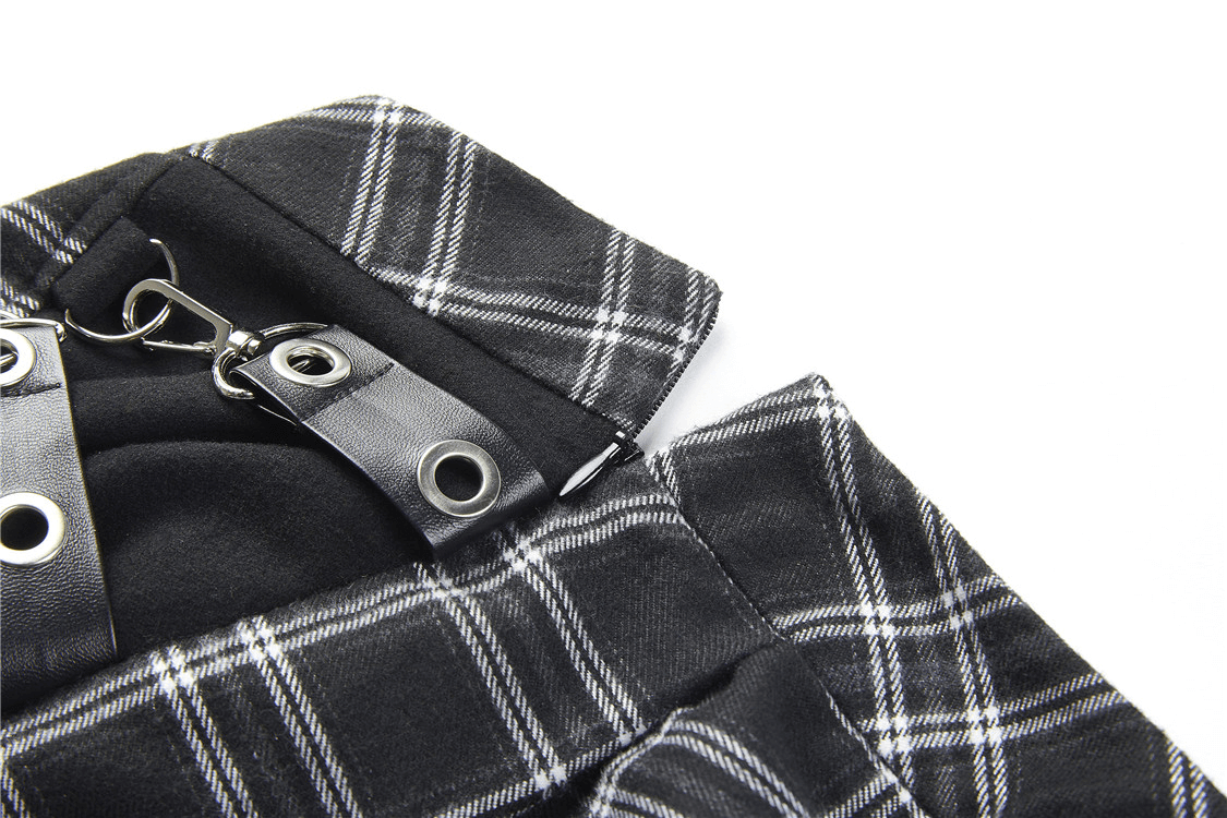 Close-up of a Grunge Gothic asymmetrical plaid skirt with large pin accents in black and white fabric.