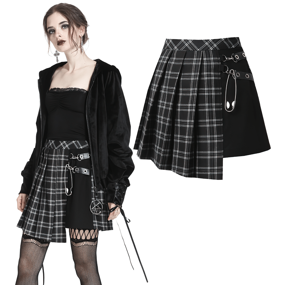 Model wearing a grunge gothic asymmetrical plaid skirt with large pin accents, showcasing edgy punk style.