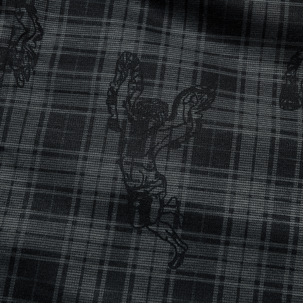 Close-up of black plaid fabric featuring angel graphics, perfect for a gothic fashion statement.