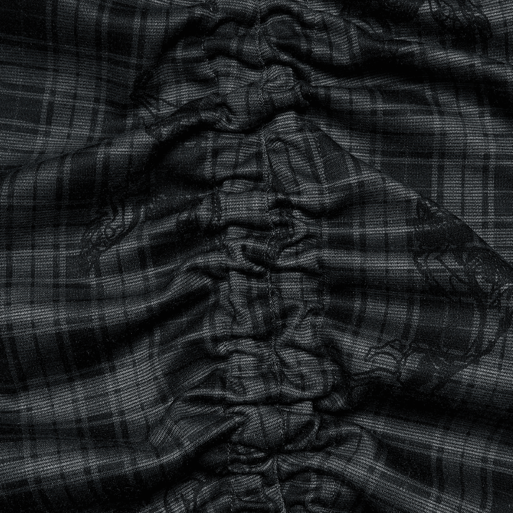 Close-up of black plaid fabric showcasing textured lace details and gathered design elements for gothic style dresses.