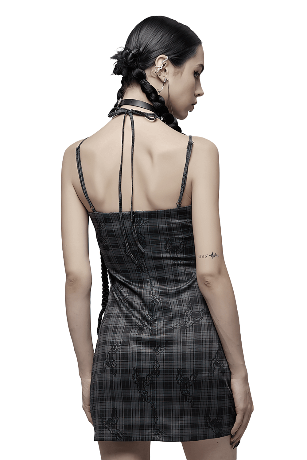 Back view of a lady in a grunge gothic lace-up mini bodycon dress with plaid pattern and adjustable straps.