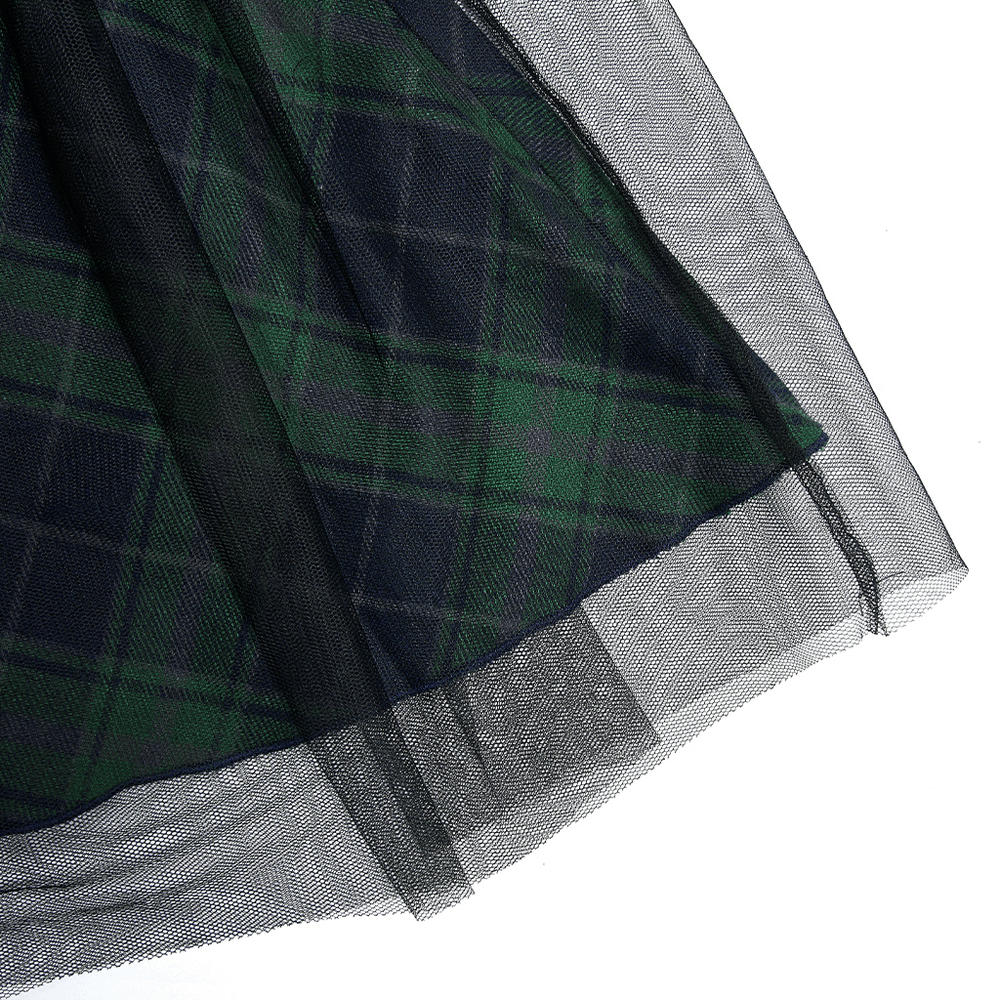 Close-up of grunge plaid high waist mini skirt featuring a stylish mesh panel and ruffled edges for an elegant look.