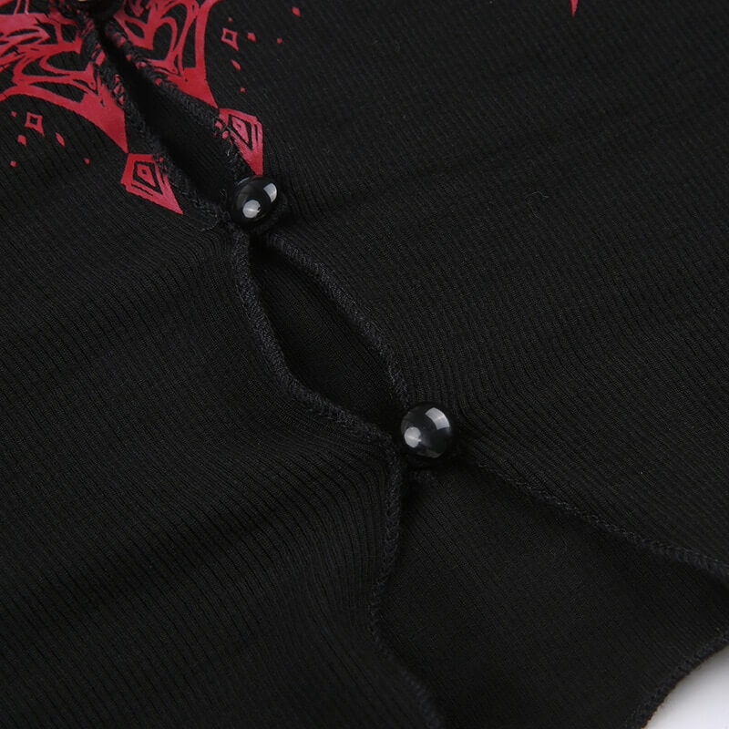 Close-up of black grunge women's long-sleeve top with red graphic design and button details.