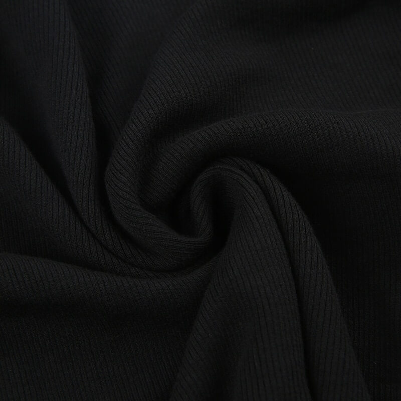 Close-up view of soft, black ribbed fabric for grunge and gothic fashion clothing.