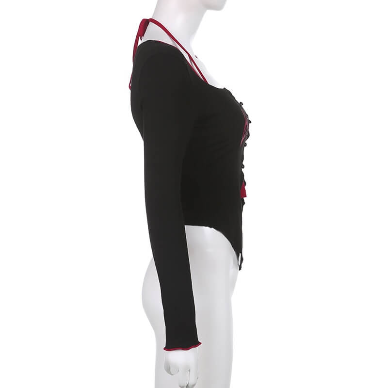 Grunge women's long-sleeve top in black with buttons, showcasing gothic aesthetic side view.