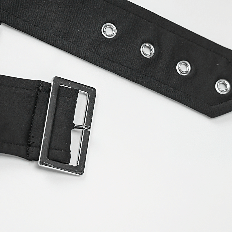 Close-up of a black belt with silver buckle and grommets, perfect for adding a grunge touch to any outfit.