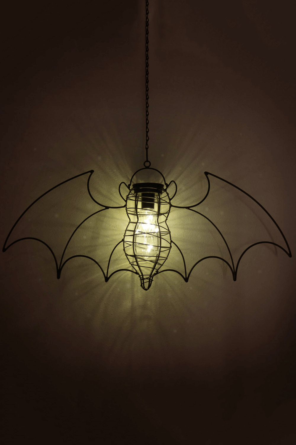 Solar-powered bat lantern light with glowing LED bulb, perfect for gothic gardens and charming ambiance.