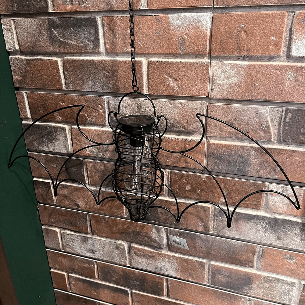 Hanging bat solar lantern with LED bulb, perfect for adding gothic charm to gardens and indoor spaces.