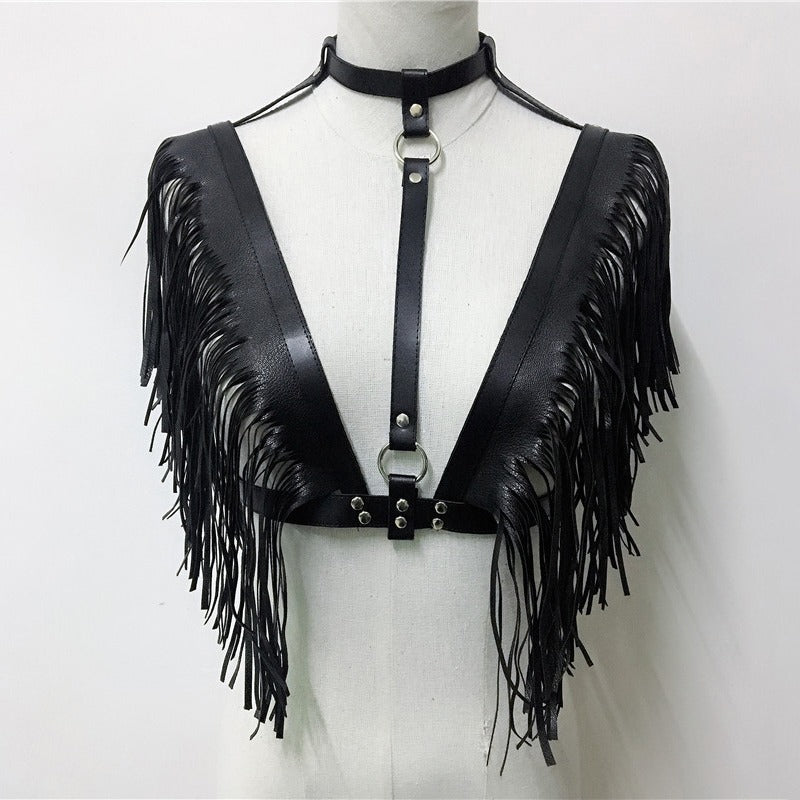 Leather crop top with fringe detailing and harness, perfect for gothic or rave outfits.