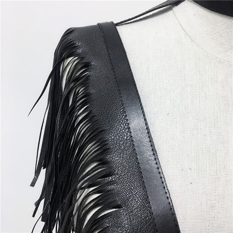 Close-up of black leather crop top with fringe detailing, perfect for rave and gothic styles.