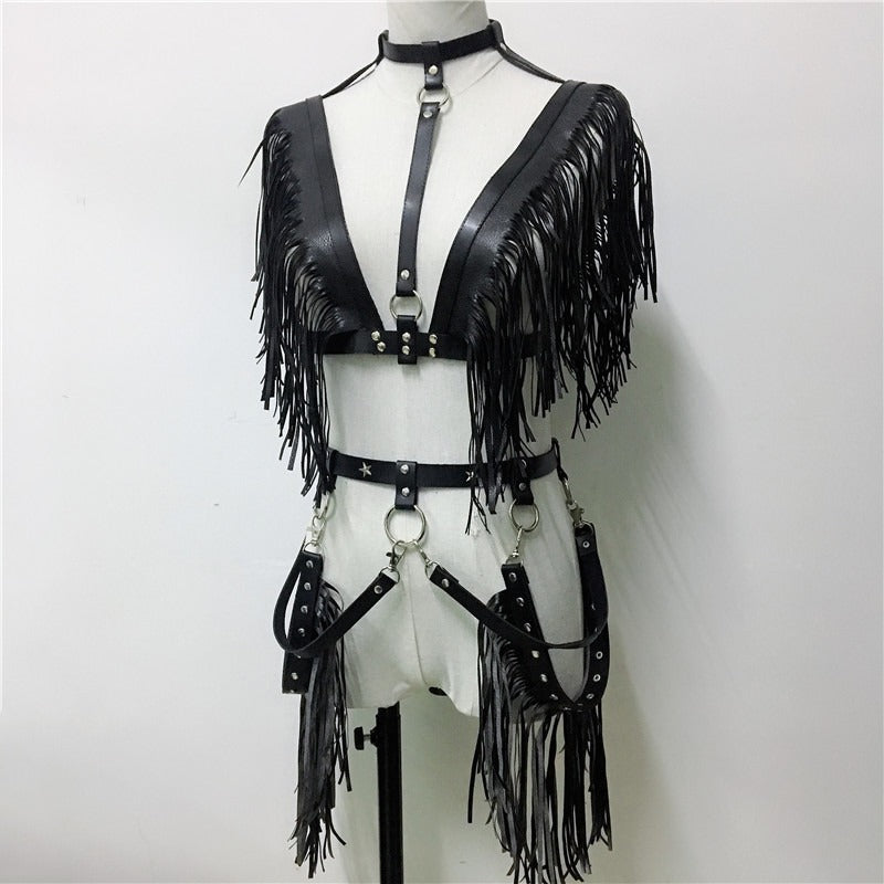 Stylish black leather crop top with fringe detailing, perfect for rave or goth fashion, featuring adjustable straps and chic design.