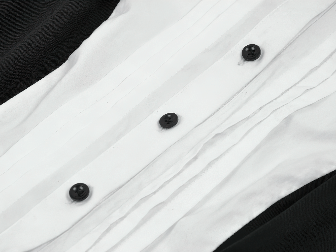 Close-up of buttons and ruffles on the Harlequin Black and White Gothic Ruffle Mini Dress.