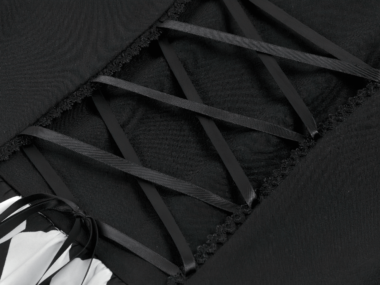 Close-up view of the details on the Harlequin Black and White Gothic Ruffle Mini Dress with lace and ribbon accents.