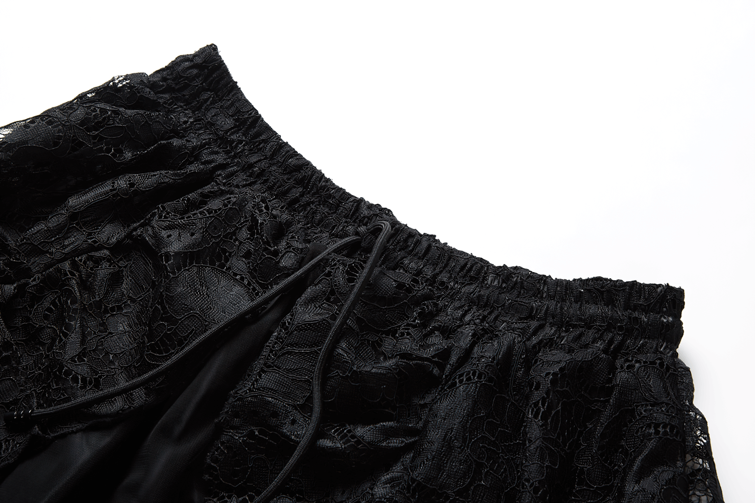 Close-up of the luxe black lace waistband of the high front low back maxi skirt, showcasing intricate floral details.