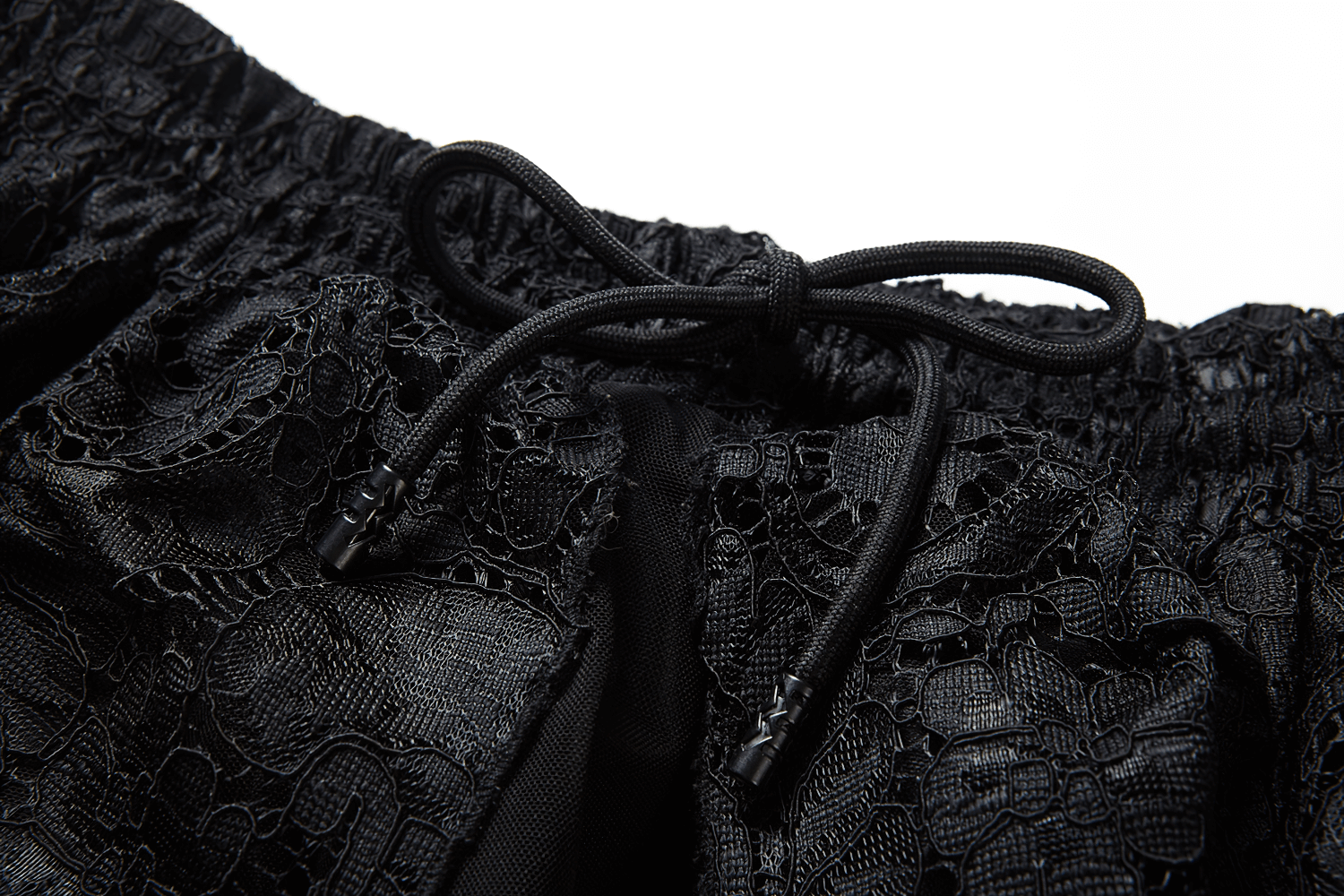 Close-up of black lace detailing and adjustable drawstring on a high-low maxi skirt.