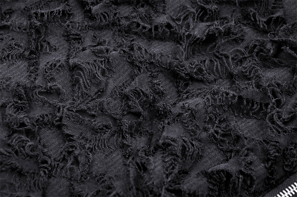 Close-up of dark distressed fabric showcasing intricate textures for a gothic high-low lace skirt.