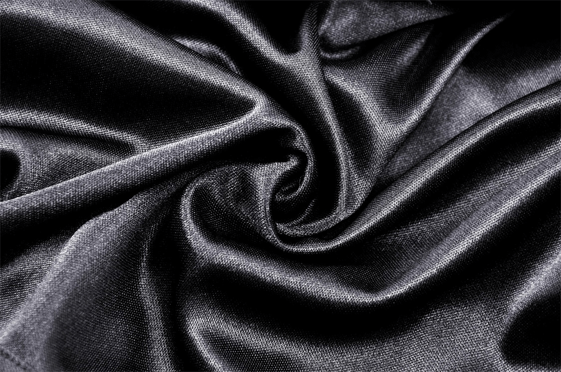 Luxurious black fabric swirling in elegant folds, perfect for gothic fashion and high-low skirts.