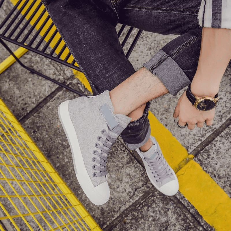 Stylish high top sneakers in grey, showing off trendy lace-up design, perfect for rock outfits and casual wear.