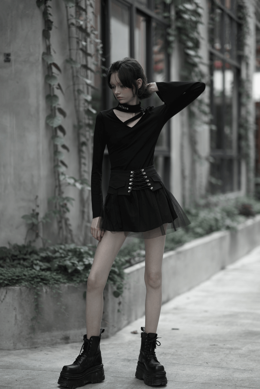 Fashionable model in a High-Waist Black Gothic Skirt with lace-up detail, showcasing punk street style.