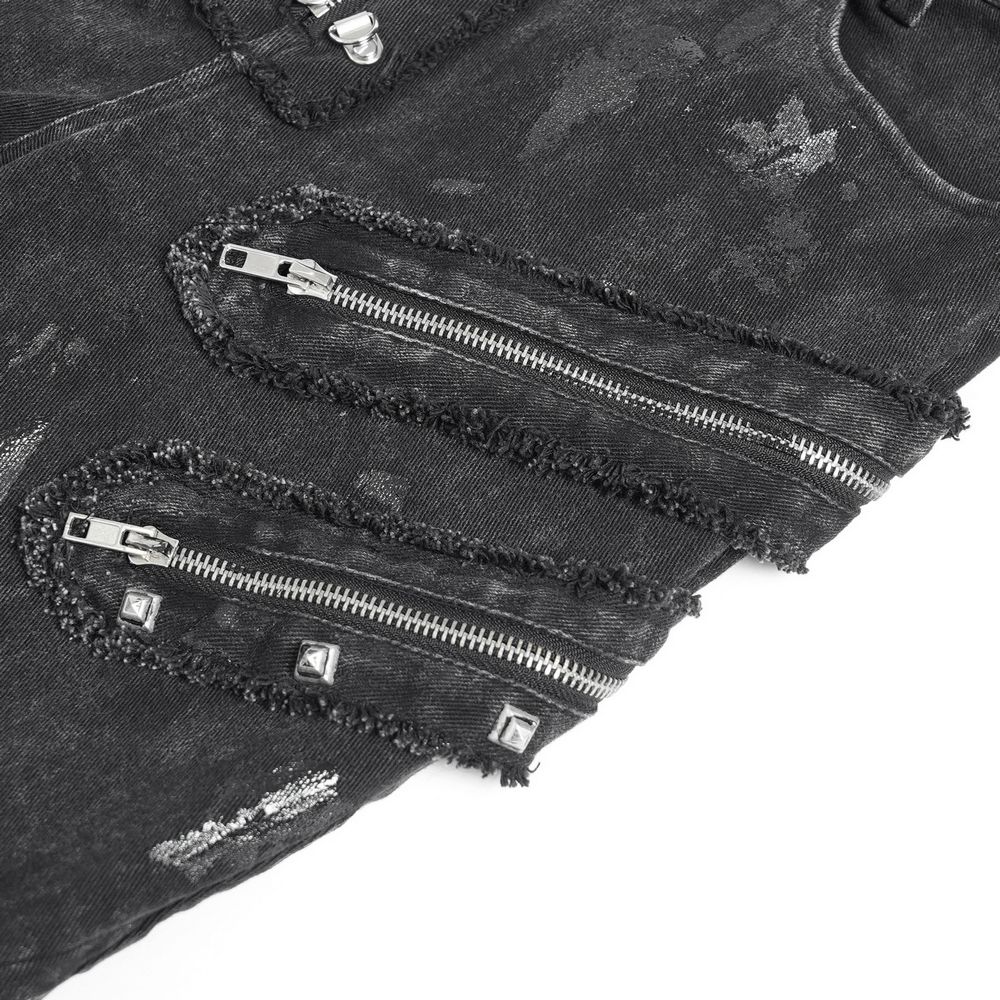 Close-up of high waist flared jeans with zipper details and metal studs for a punk-inspired look.