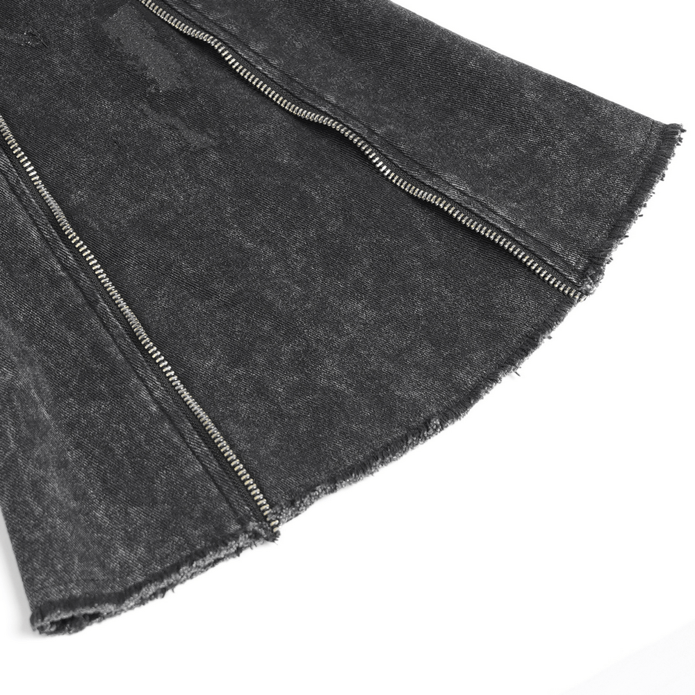Close-up of high waist flared jeans featuring edgy zipper and frayed hem details in dark denim.