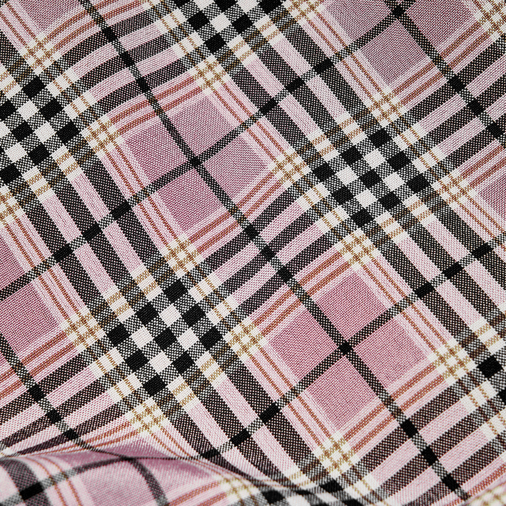 Close-up of pink and black plaid fabric, showcasing bold geometric patterns for a gothic mini skirt.